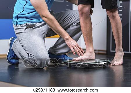 Physical therapist measuring weight of teenage boy View Large Photo Image Stock Image - Physical therapist measuring weight of teenage boy. Fotosearch