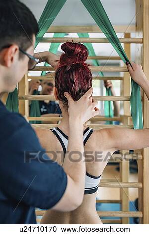 Stock Image - Physical therapist with teenage girl. Fotosearch