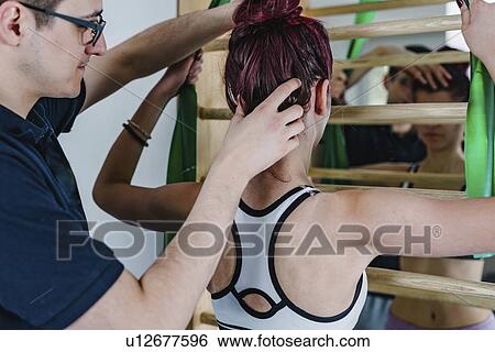 Stock Photograph - Physical therapist with teenage girl. Fotosearch