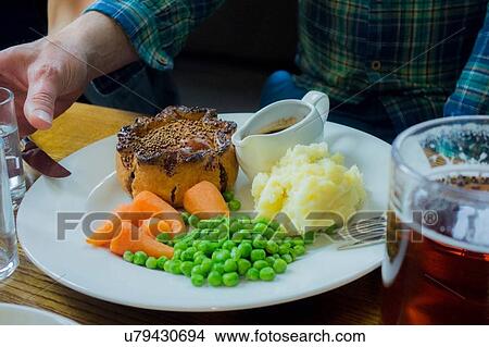 Pie, mash and peas meal with beer in pub View Large Photo Image Picture - Pie, mash and peas meal with beer in pub. Fotosearch