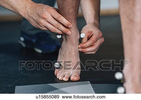 Stock Photo - Placing markers for gait analysis. Fotosearch