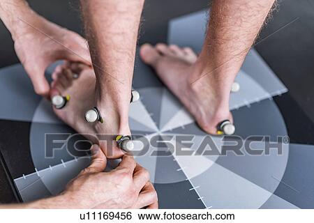Stock Photograph - Placing markers for posture analysis. Fotosearch