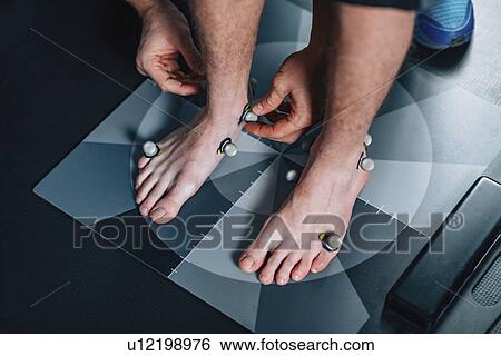 Stock Photograph - Placing markers for posture analysis. Fotosearch