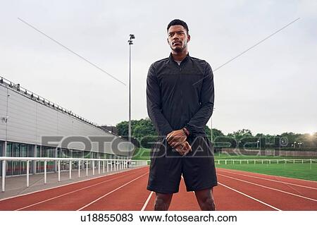 Stock Image - Portrait of athlete on running track. Fotosearch