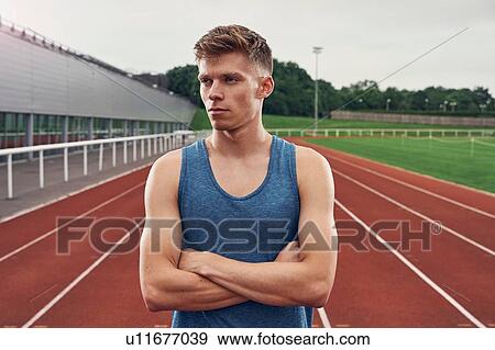 Stock Photo - Portrait of athlete on running track. Fotosearch