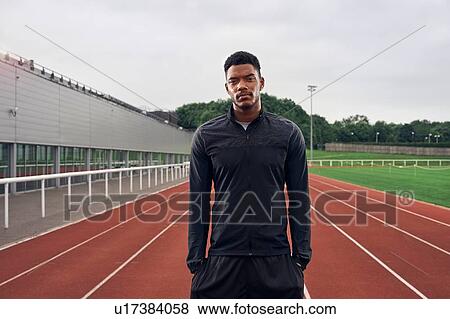 Stock Photo - Portrait of athlete on running track. Fotosearch
