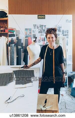 Stock Photo - Portrait of fashion designer in her work studio. Fotosearch