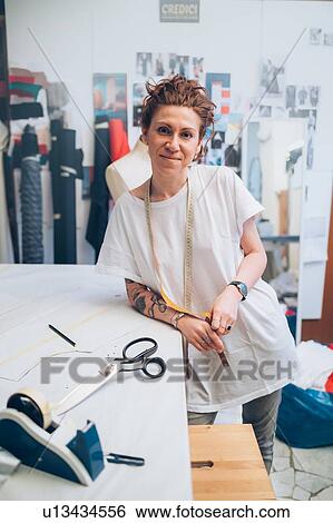 Stock Photograph - Portrait of fashion designer in her work studio. Fotosearch