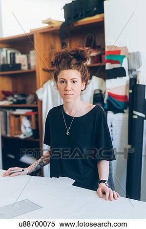 Stock Photography - Portrait of fashion designer in her work studio. Fotosearch