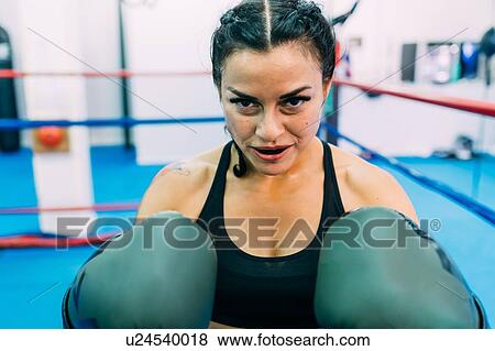 Portrait of female boxer in boxing ring View Large Photo Image Stock Photo - Portrait of female boxer in boxing ring. Fotosearch
