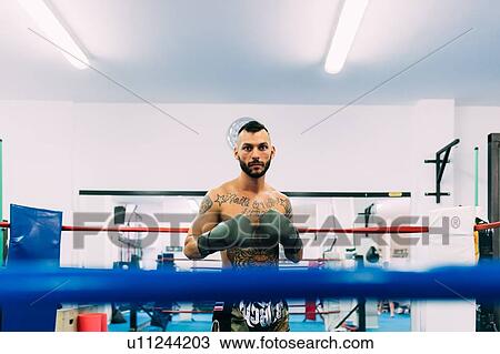 Stock Image - Portrait of male boxer in boxing ring. Fotosearch