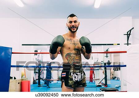 Stock Image - Portrait of male boxer in boxing ring. Fotosearch