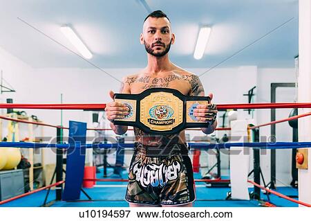 Portrait of male boxer with championship belt in boxing ring View Large Photo Image Stock Photo - Portrait of male boxer with championship belt in boxing ring. Fotosearch