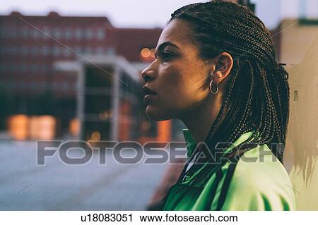 Portrait of woman with braided hairstyle, Milan Italy View Large Photo Image Stock Image - Portrait of woman with braided hairstyle, Milan Italy. Fotosearch