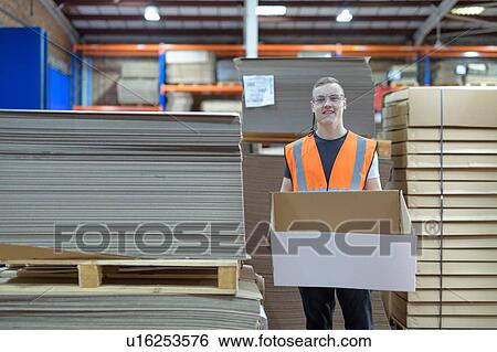 Stock Photograph - Portrait of worker in cardboard box factory. Fotosearch