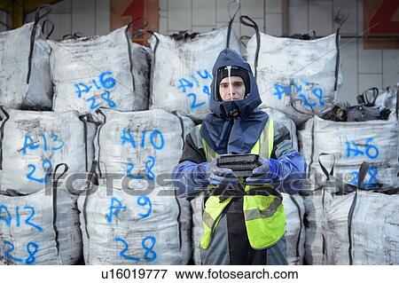 Stock Photo - Portrait of worker in recycling factory. Fotosearch