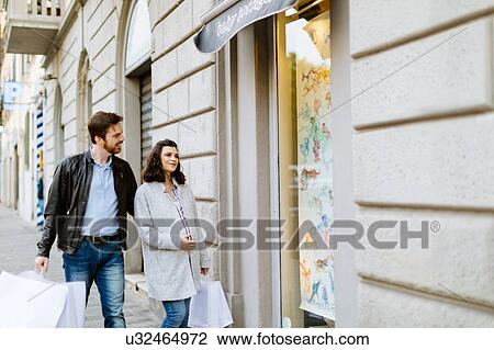 Stock Image - Pregnant couple window shopping, Florence, Italy. Fotosearch
