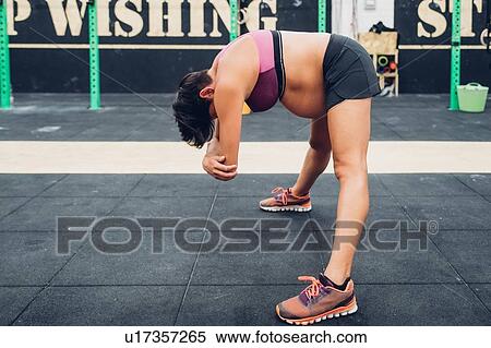 Pregnant woman bending forward at workout View Large Photo Image Stock Photography - Pregnant woman bending forward at workout. Fotosearch