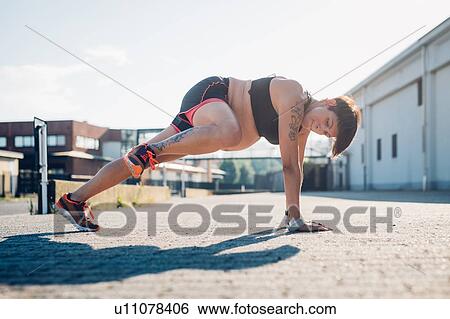 Pregnant woman doing push ups outdoors View Large Photo Image Stock Photograph - Pregnant woman doing push ups outdoors. Fotosearch