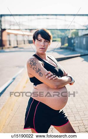 Pregnant woman in workout clothes in sunshine View Large Photo Image Stock Image - Pregnant woman in workout clothes in sunshine. Fotosearch