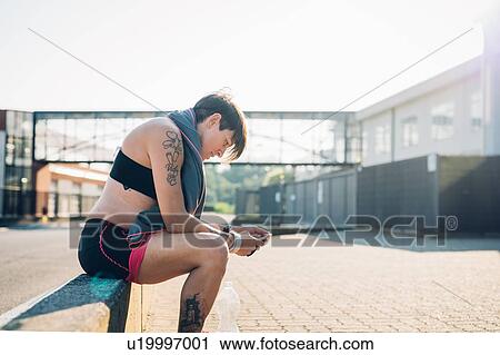Pregnant woman reading text message at workout View Large Photo Image Stock Image - Pregnant woman reading text message at workout. Fotosearch