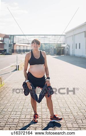 Pregnant woman taking break from workout View Large Photo Image Picture - Pregnant woman taking break from workout. Fotosearch