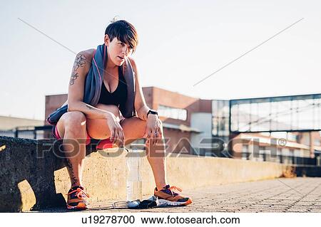 Pregnant woman taking break from workout View Large Photo Image Stock Image - Pregnant woman taking break from workout. Fotosearch