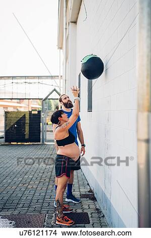 Pregnant woman throwing exercise ball View Large Photo Image Picture - Pregnant woman throwing exercise ball. Fotosearch