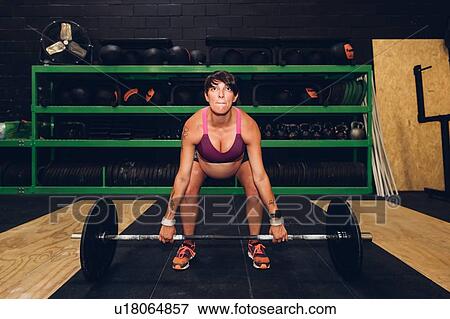 Pregnant woman using bar bell in gym View Large Photo Image Stock Photo - Pregnant woman using bar bell in gym. Fotosearch