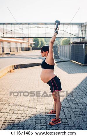 Pregnant woman using kettlebell outdoors View Large Photo Image Stock Photography - Pregnant woman using kettlebell outdoors. Fotosearch