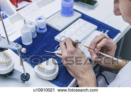 Stock Image - Prosthetic dentistry technician at work. Fotosearch