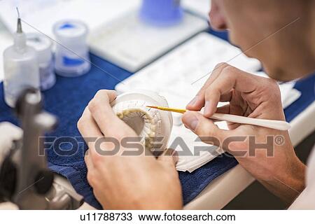 Stock Image - Prosthetic dentistry technician at work. Fotosearch
