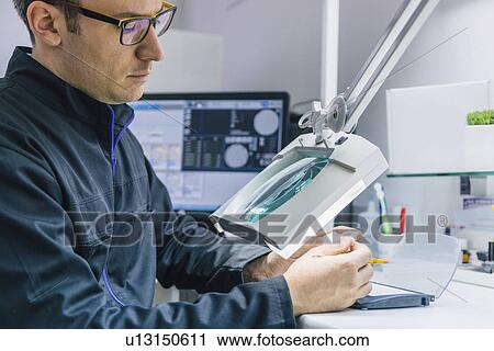 Stock Image - Prosthetic dentistry technician at work. Fotosearch