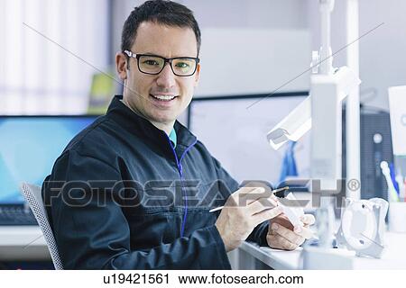 Stock Image - Prosthetic dentistry technician at work. Fotosearch