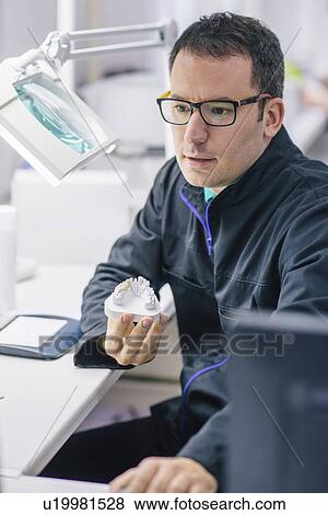 Stock Photo - Prosthetic dentistry technician at work. Fotosearch