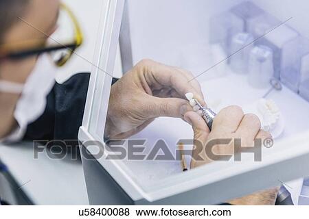 Stock Photo - Prosthetic dentistry technician at work. Fotosearch
