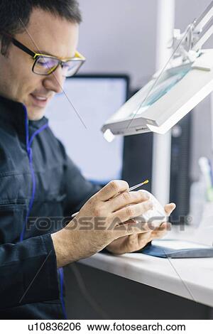 Stock Photograph - Prosthetic dentistry technician at work. Fotosearch