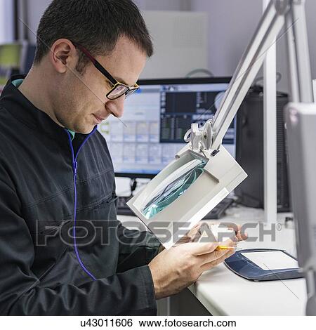 Stock Photograph - Prosthetic dentistry technician at work. Fotosearch