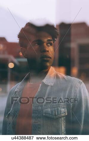 Reflection of man and buildings in glass window View Large Photo Image Stock Photo - Reflection of man and buildings in glass window. Fotosearch
