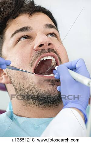Removing dental tartar View Large Photo Image Stock Photo - Removing dental tartar. Fotosearch