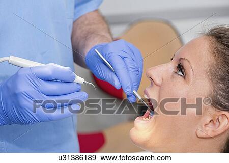 Removing dental tartar View Large Photo Image Stock Photo - Removing dental tartar. Fotosearch