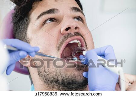 Removing dental tartar View Large Photo Image Stock Photograph - Removing dental tartar. Fotosearch