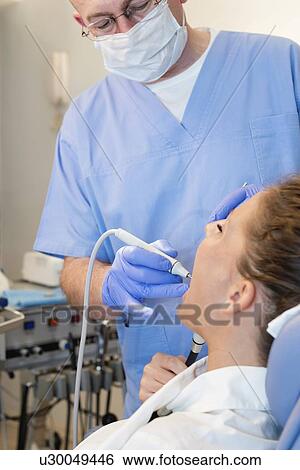 Stock Photograph - Removing dental tartar. Fotosearch