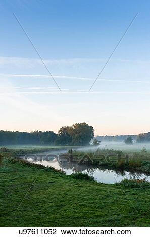 Stock Image - River Mark in early morning mist, Netherlands. Fotosearch