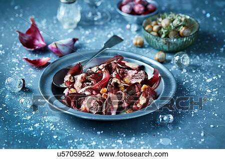 Stock Image - Roasted beetroot in bowl with hazelnut salad, seasonal Christmas food. Fotosearch