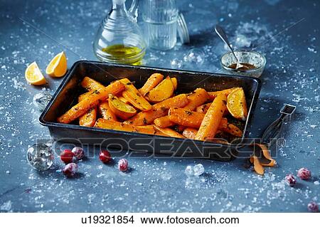Roasted carrots in roasting tin, seasonal christmas food View Large Photo Image Picture - Roasted carrots in roasting tin, seasonal christmas food. Fotosearch