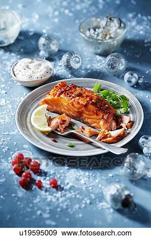 Stock Photo - Roasted salmon fillet on plate, seasonal Christmas food. Fotosearch