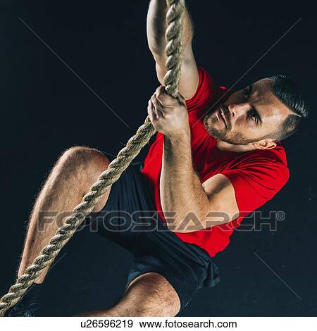 Stock Photo - Rope climbing exercise. Fotosearch