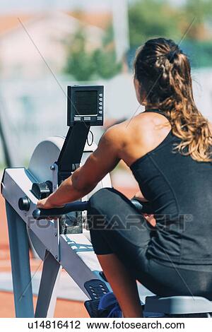 Stock Image - Rowing machine workout. Fotosearch