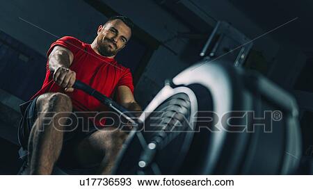 Stock Image - Rowing machine workout. Fotosearch
